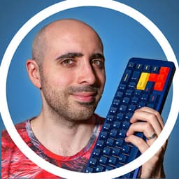 Nicola Sagliano, creator of CreatorLink, holding a custom mechanical keyboard